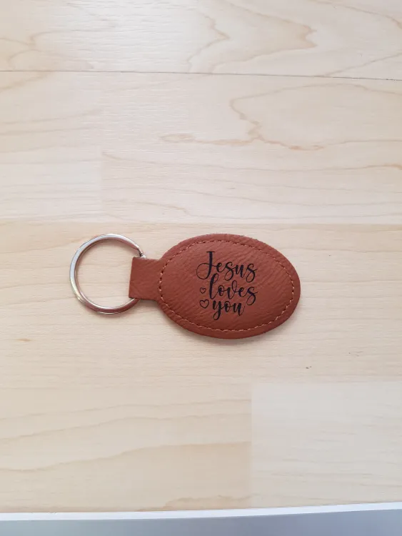 Schlüsselanhänger, "Jesus loves you" - bronze, Kunstleder, mit graviertem Schriftzug